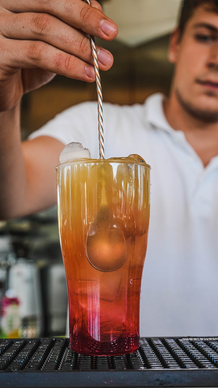 a glass of red and orange beverage with spoon Get the best alcohol treatment