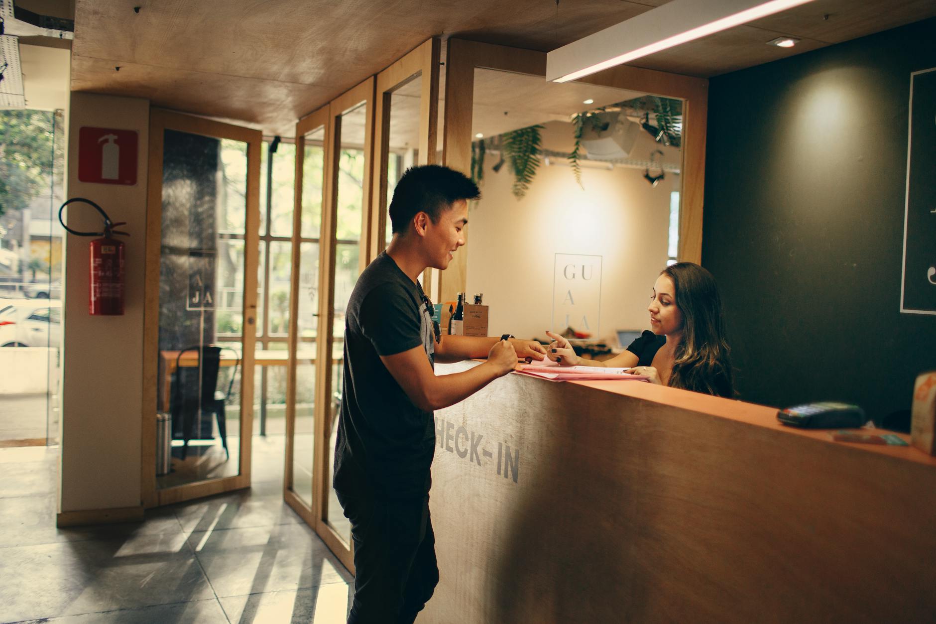 man standing in front of front desk. Rehab options for overseas citizens