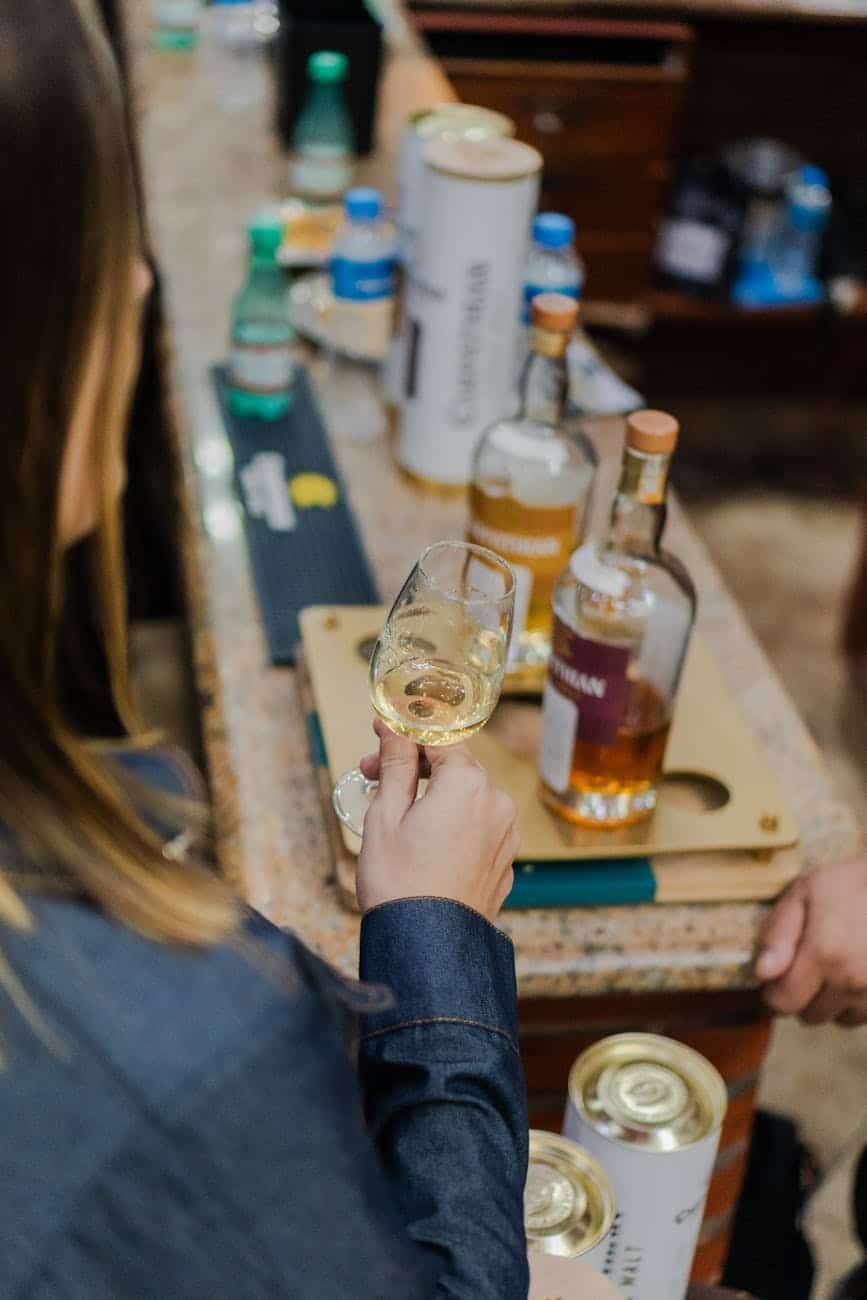 person sampling whiskey at a tasting event