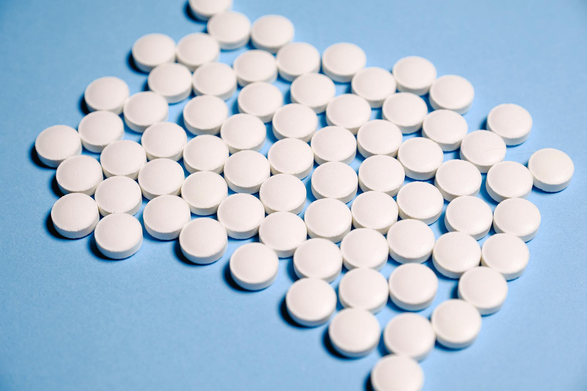 white medication pill on blue textile Codeine Addiction: Spotting the Signs