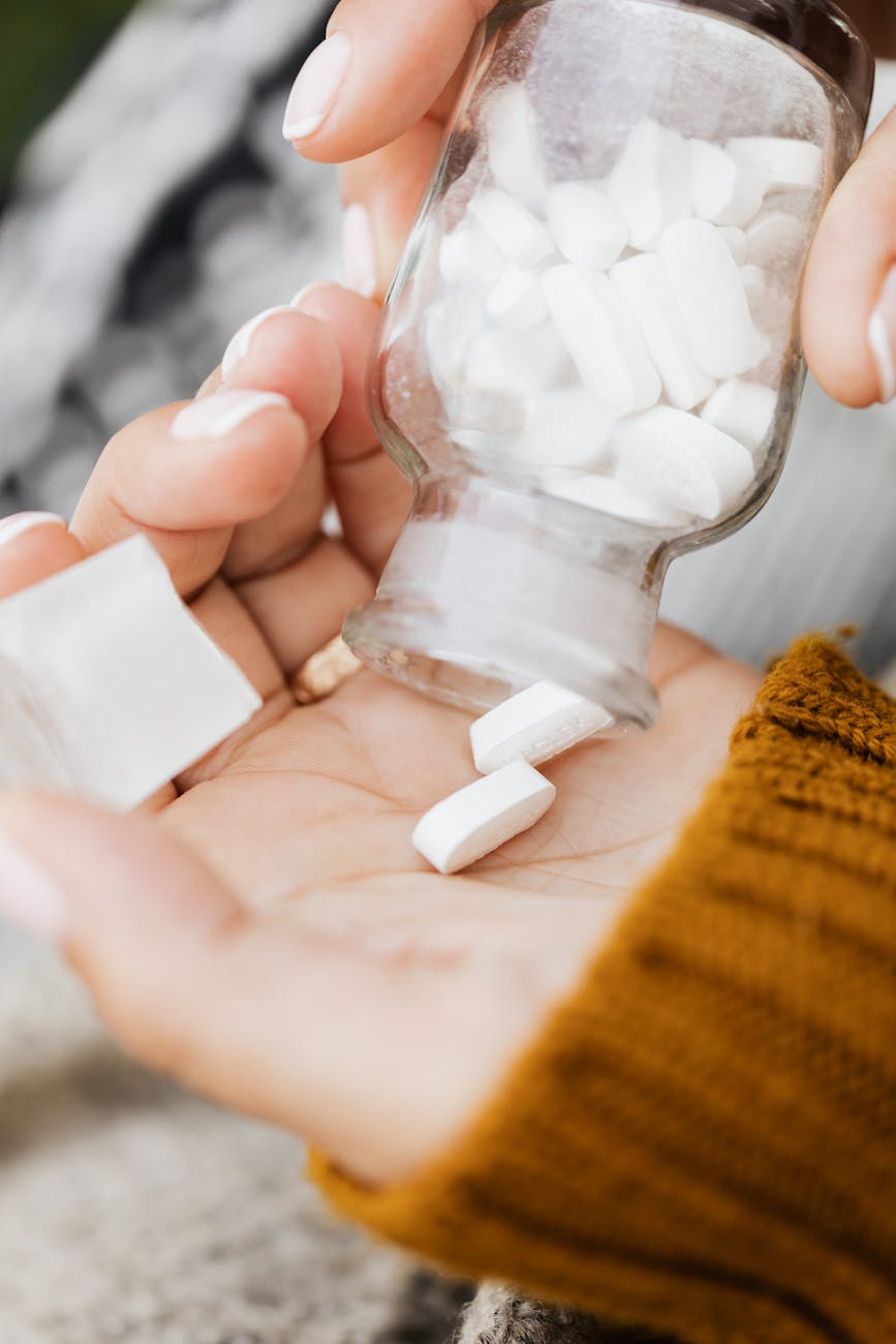 a close up shot of a person taking medicine from a bottle Codeine Addiction: Spotting the Signs
