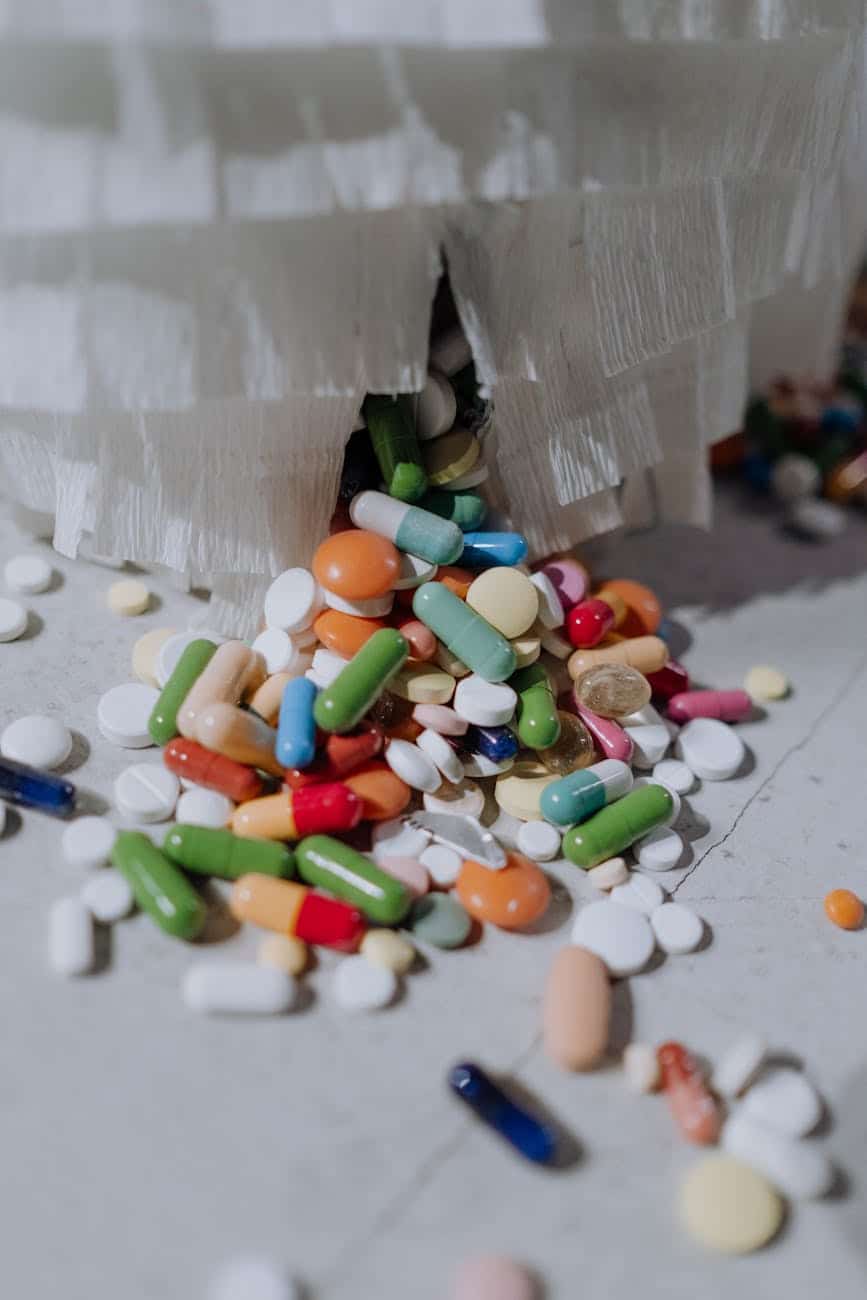 close up of scattered pills in different shapes sizes and colors