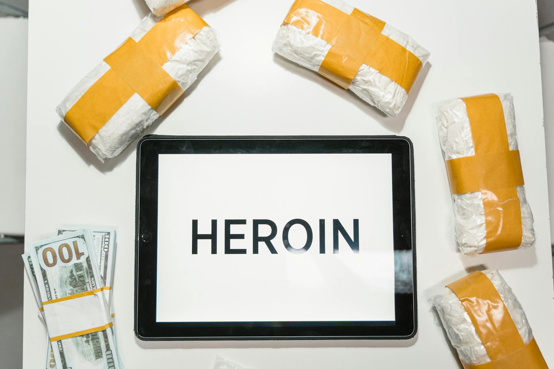 conceptual packages of heroin over a white table Low Cost Heroin Home Detox