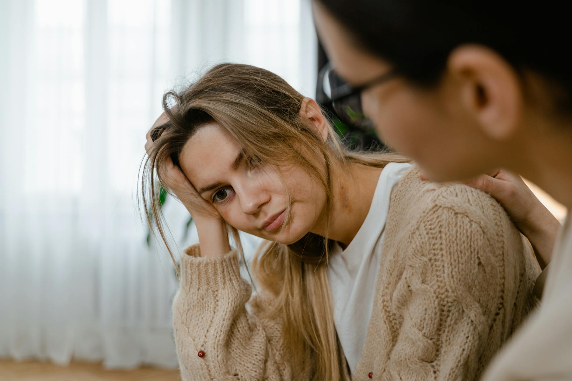 person patting the stressed woman on her shoulder Getting Help For Addiction: Breaking The Stigma
