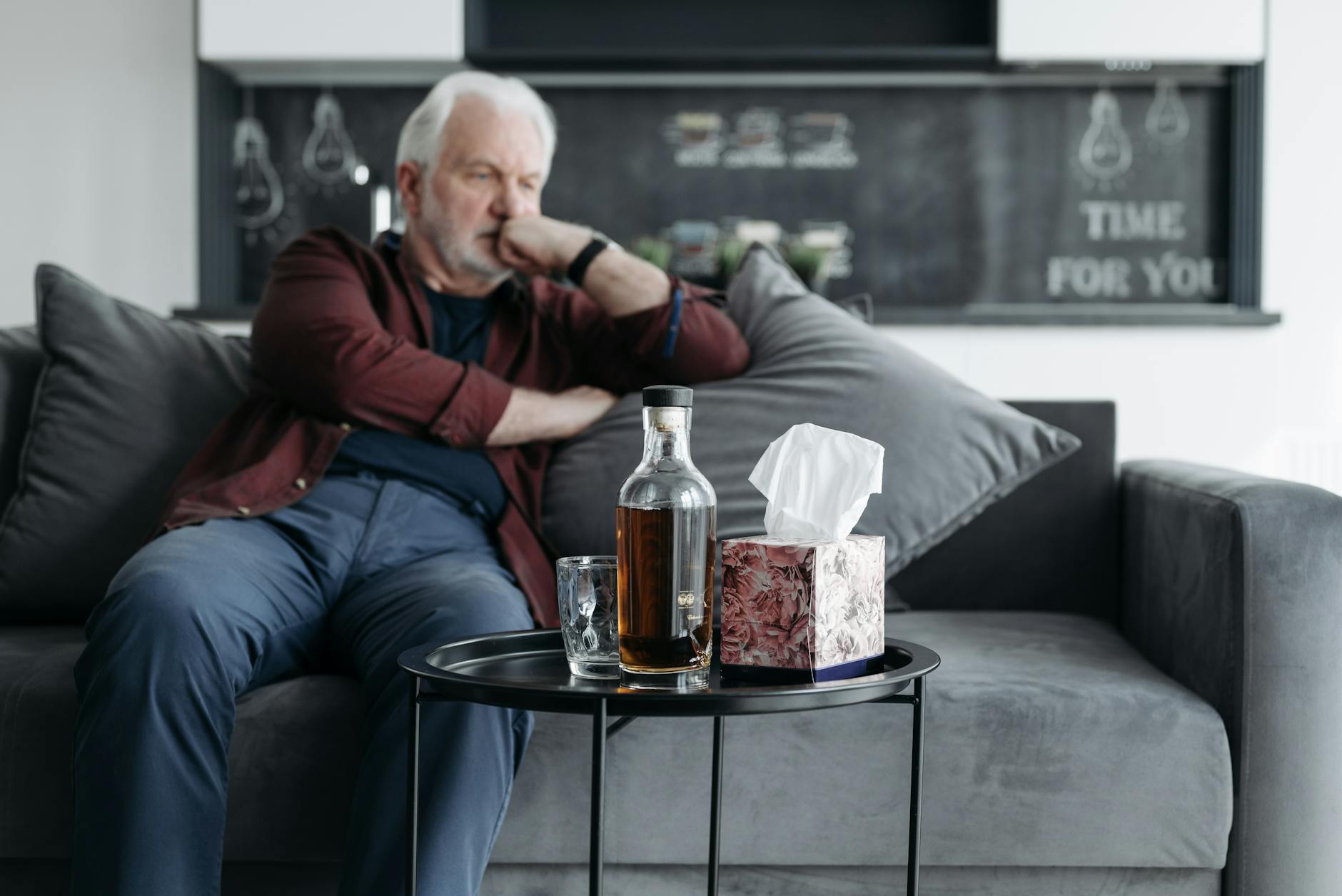 a man sitting on the couch Is Home Alcohol Detox Safe?