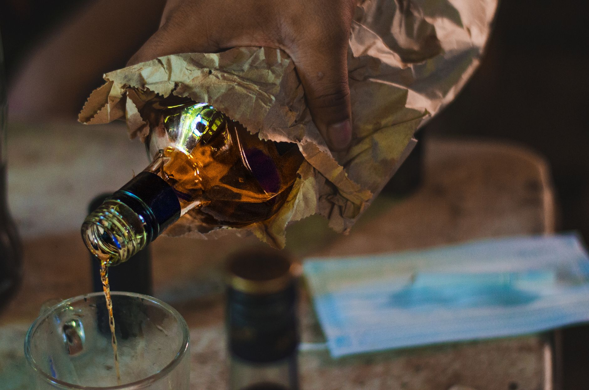 close up shot of a person pouring a liquor on a glass home detox